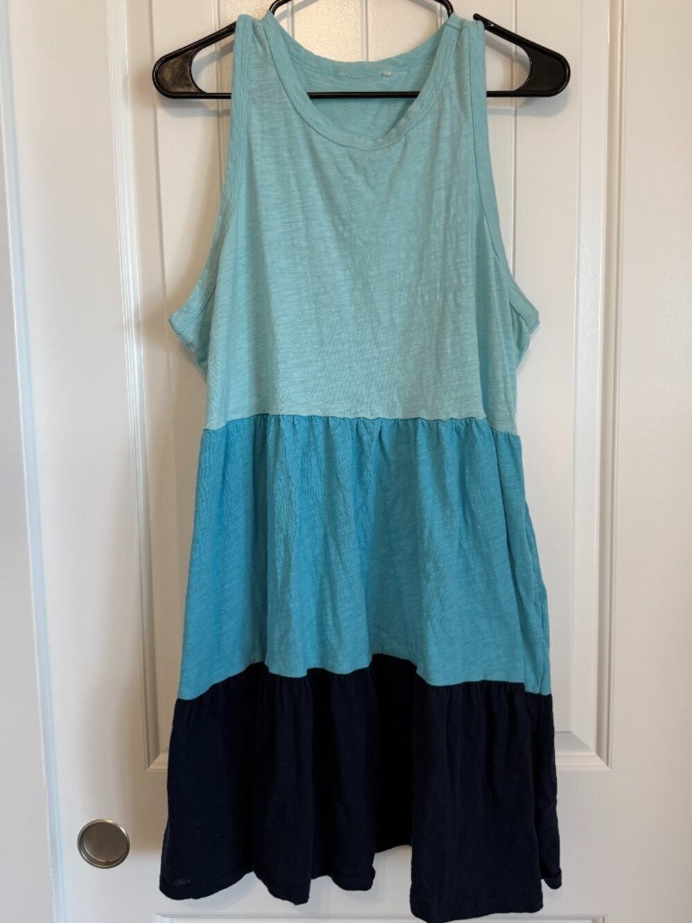 Sleeveless tiered mini dress featuring a blue ombré color block design